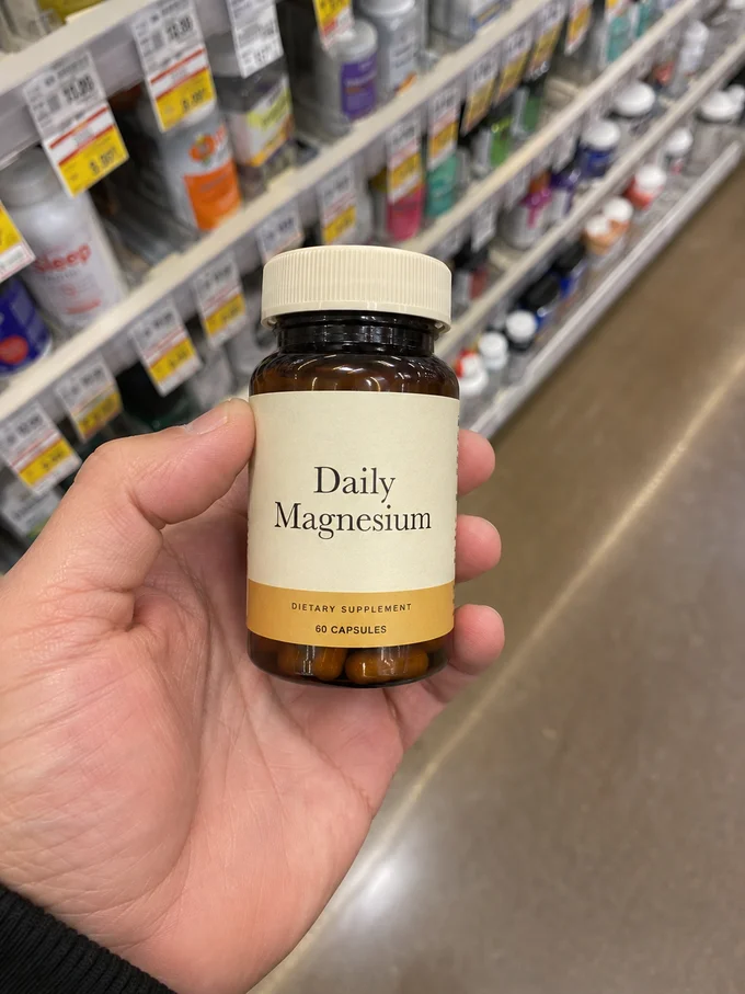 Illustrative magnesium supplement held in a shop